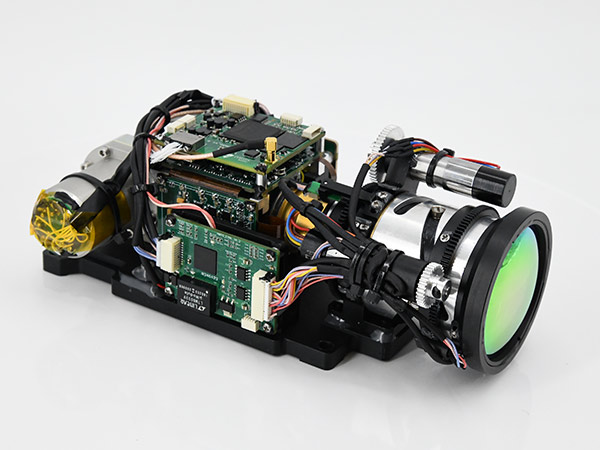 Cooled thermal module/core with lens